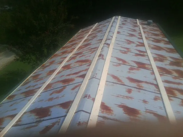 Rusted metal roof panels with new wood purlins before replacement — Storm Damage Roof Repair in Union Hall by Roofing Brothers