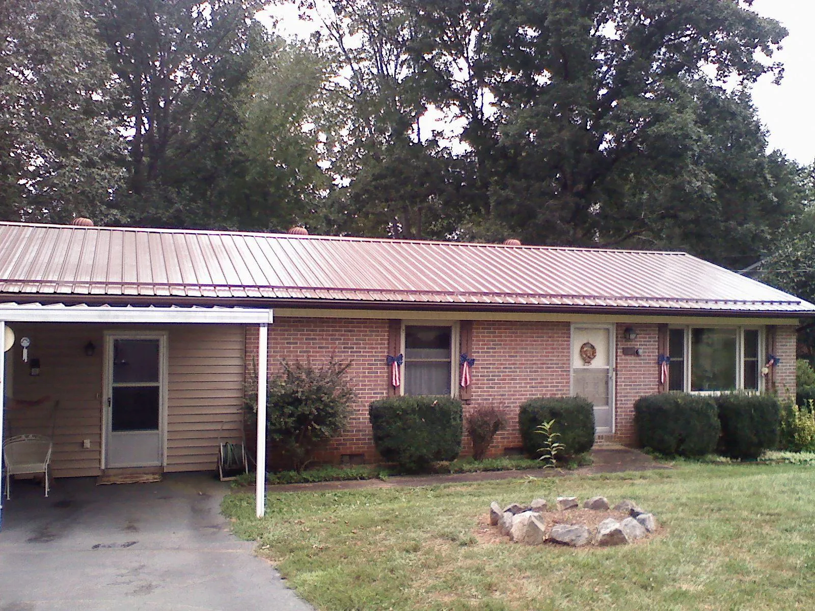 Bronze metal roof and carport on a brick ranch home — Roof Repair work by our crew in Union Hall