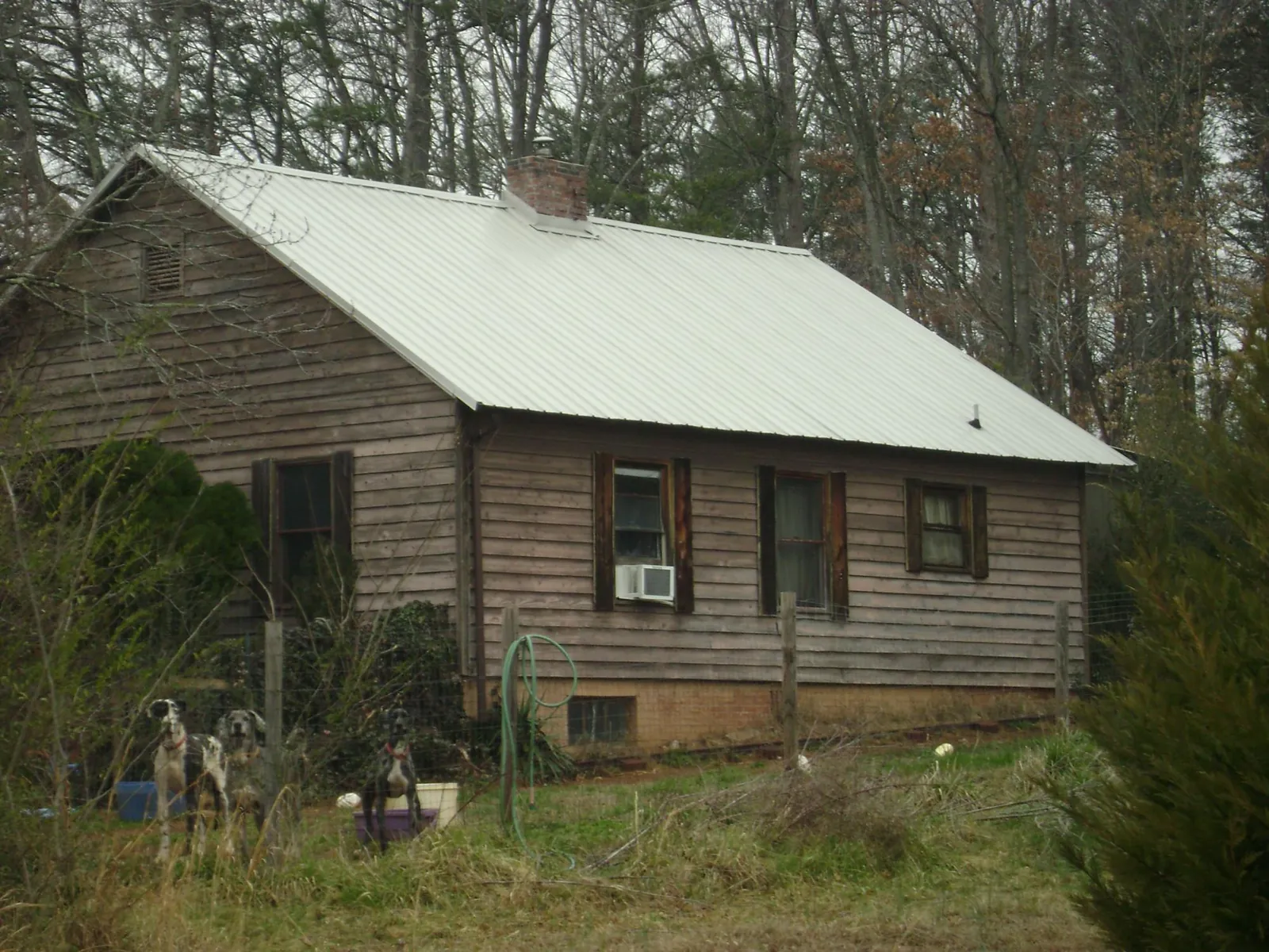White metal roof on an old wood sided farmhouse, from a Metal Roof Installation job in Union Hall